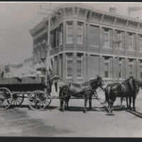 Horse-drawn wagon in front of First National Bank